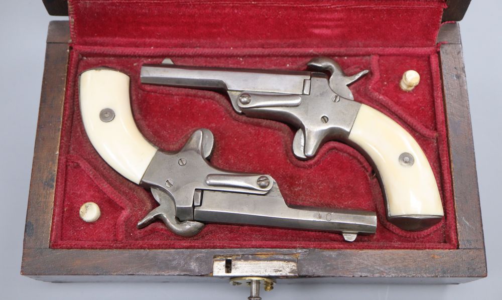 A cased pair of pin-fire muff pistols, late 19th/early 20th century,